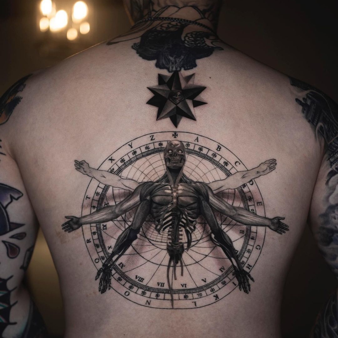 Intricate back tattoo featuring anatomical human figure