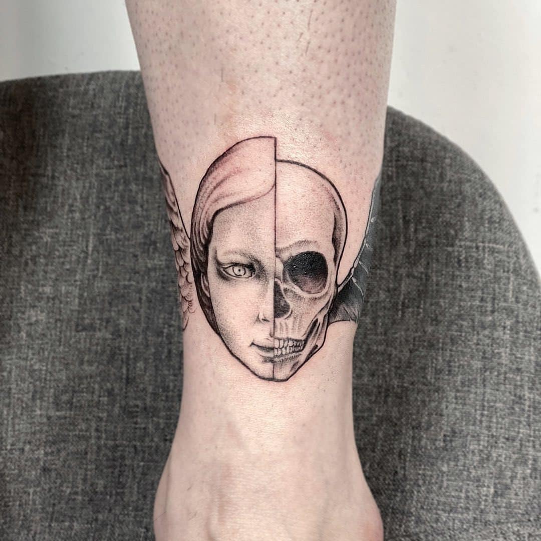 Tattoo of a woman's face and a skull on an ankle.