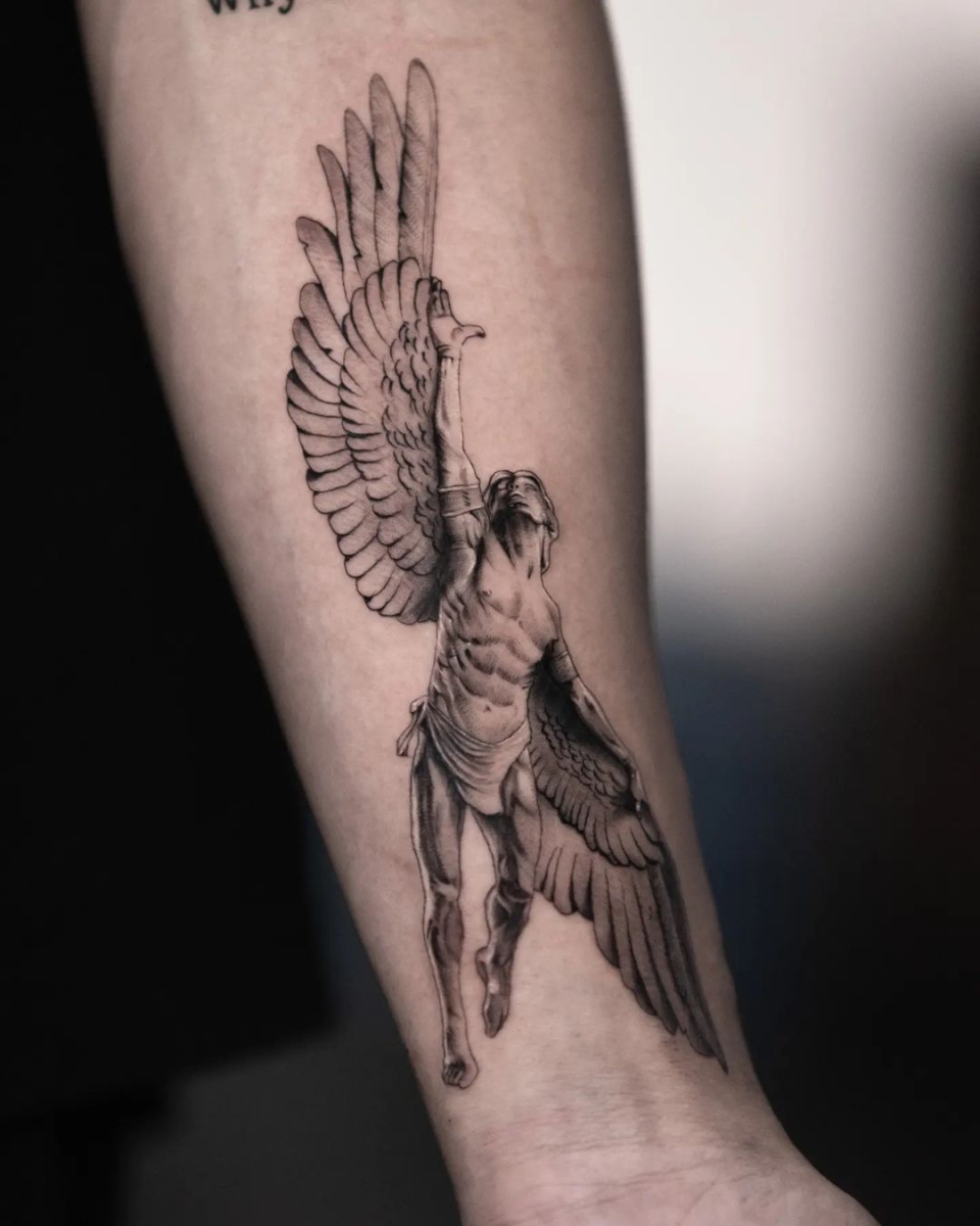 Detailed tattoo of a winged figure on the arm