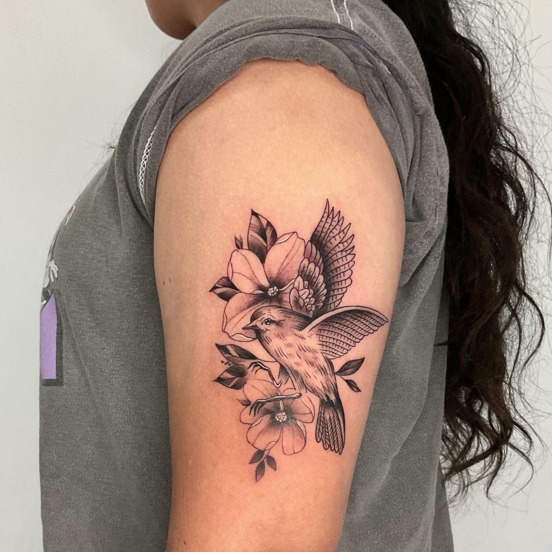 Detailed tattoo of a bird on a person's arm