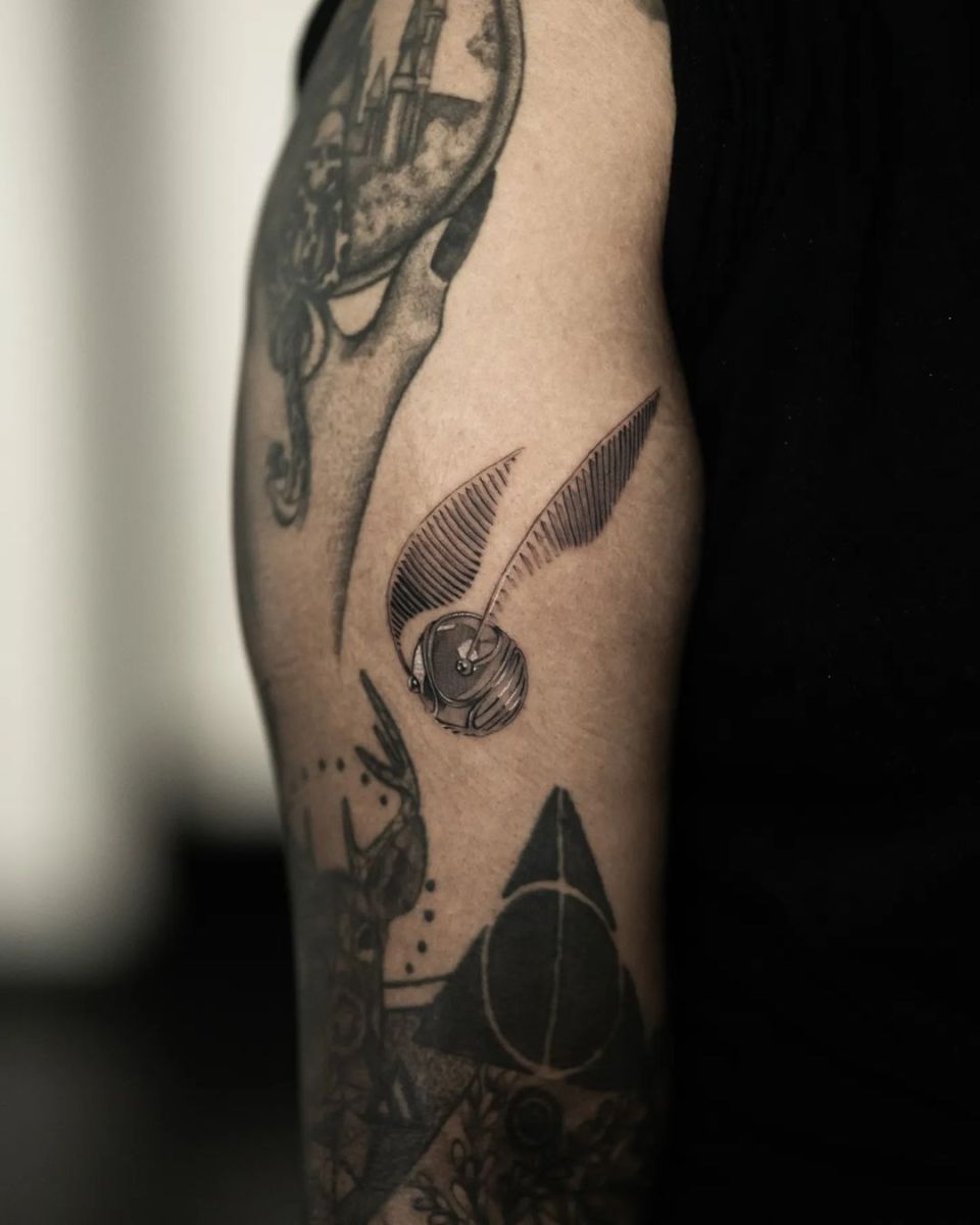 Close-up of a tattoo on a person's arm featuring an owl.