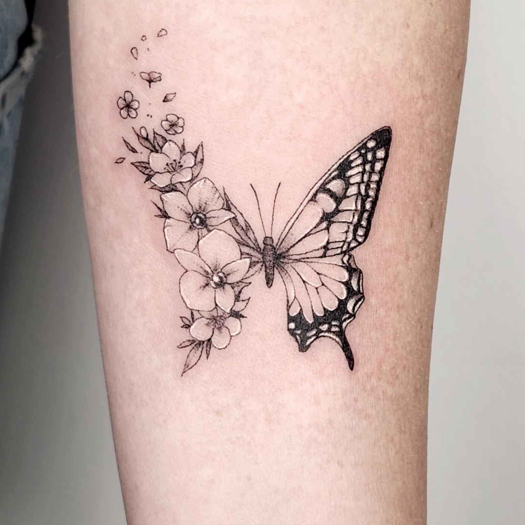Black and white butterfly tattoo with flowers