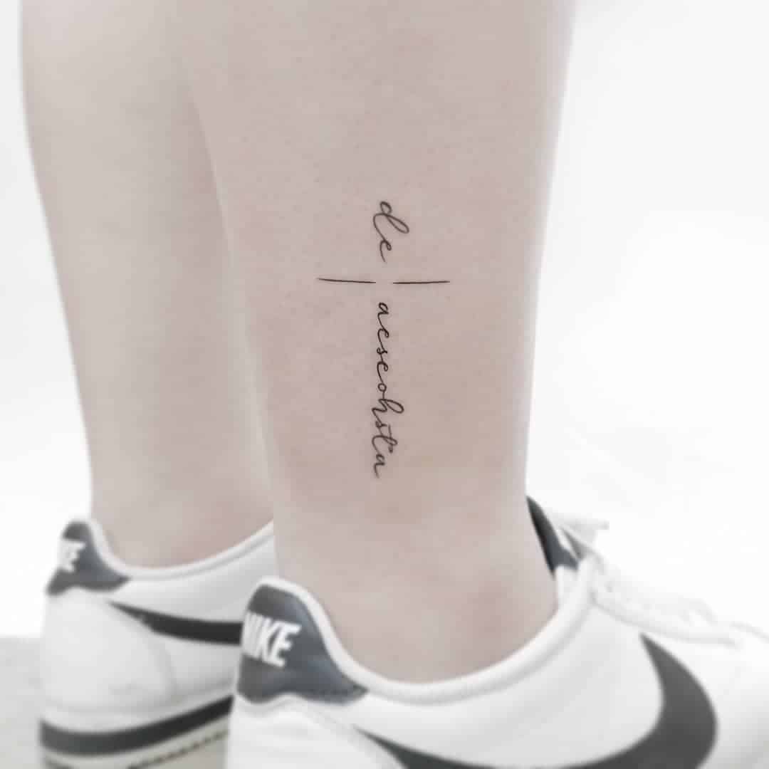 Close-up of a tattoo on a leg with stylish sneakers.