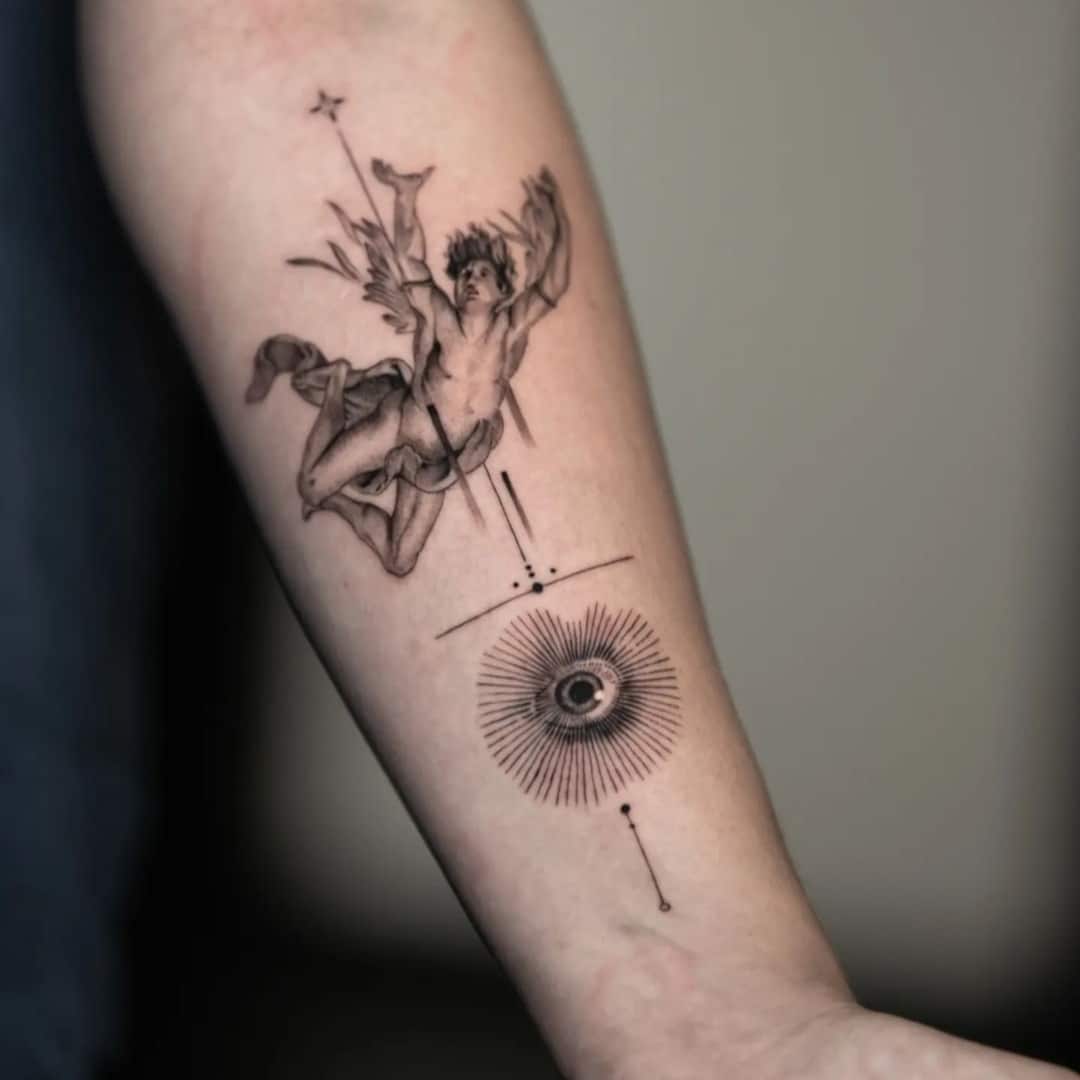 Intricate tattoo depicting a winged figure and an eye symbol