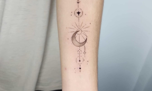 Intricate moon and star tattoo on arm
