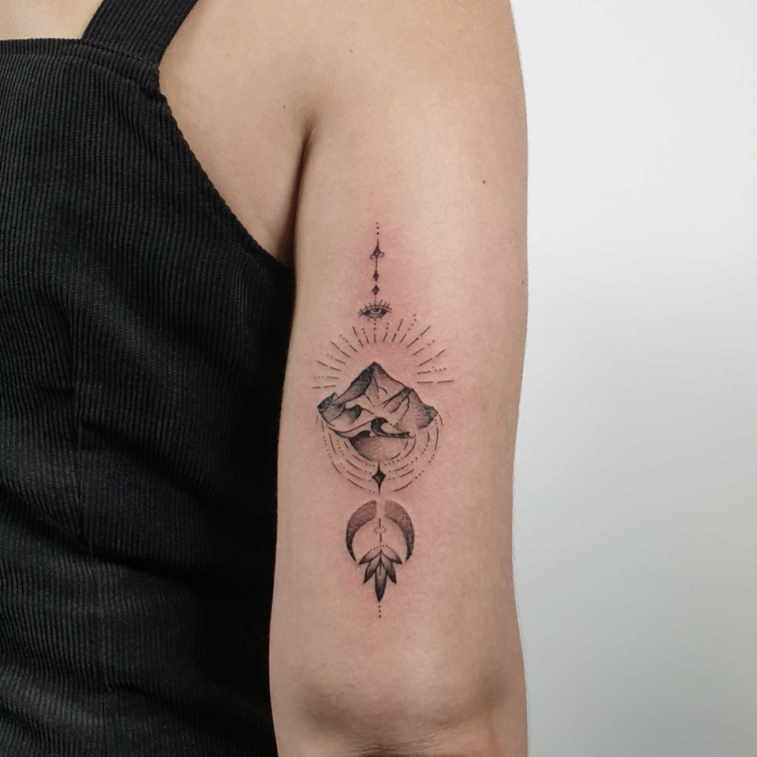Stylish mountain tattoo on arm showcasing intricate details.