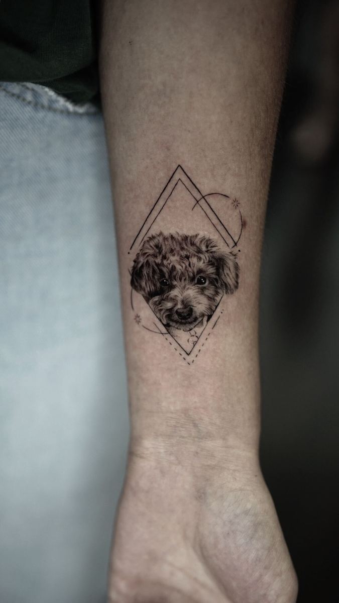 Detailed tattoo of a dog on a person's arm