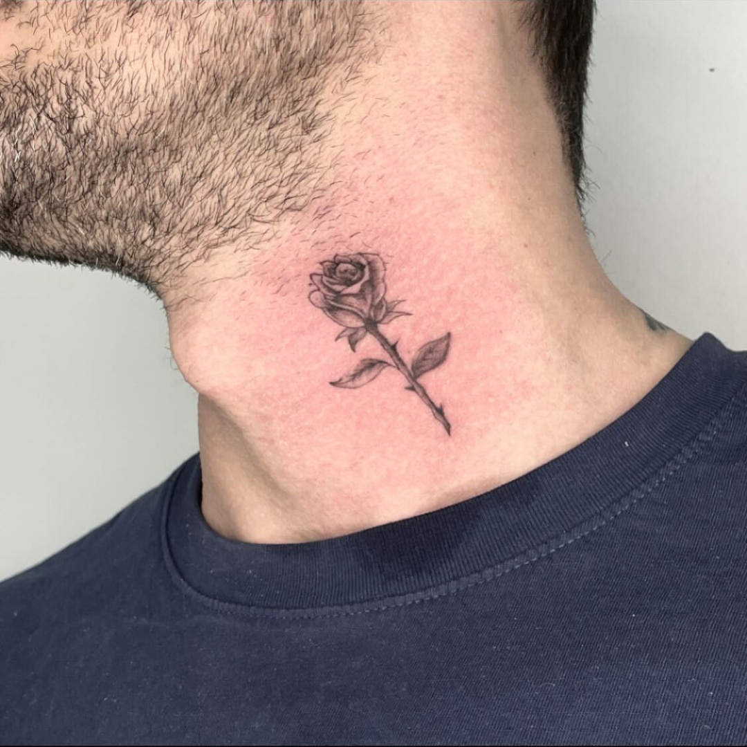 Tattoo of a rose on a man's neck
