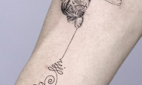 Tattoo of a sleeping tiger with elegant script