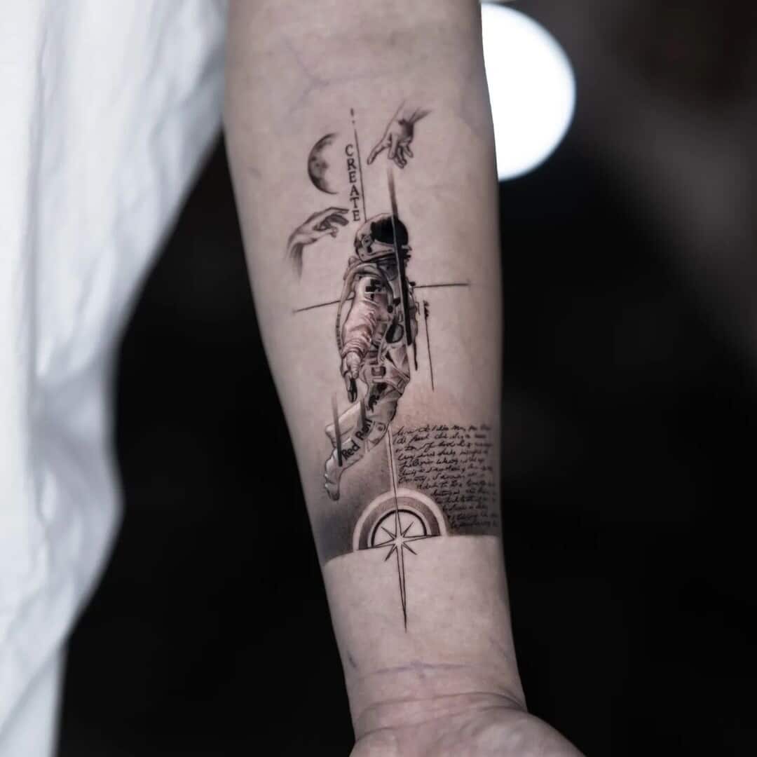 Tattoo of an astronaut with hands above and compass