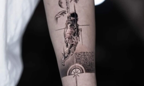 Intricate astronaut tattoo design on forearm