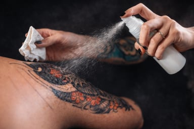 Close-up of tattoo care with spray and cloth