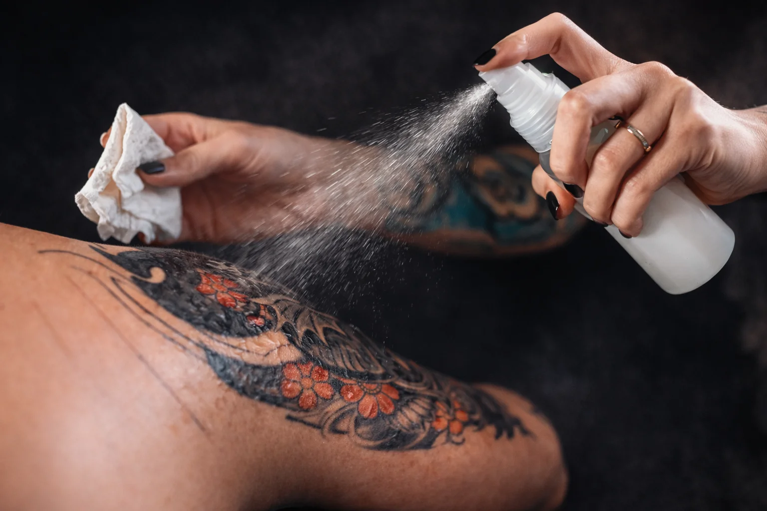 Close-up of tattoo care with spray and cloth