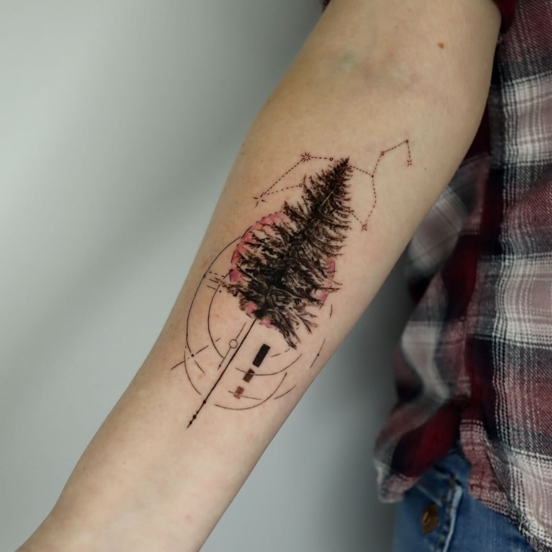Tattoo of a tree design on forearm with geometric elements