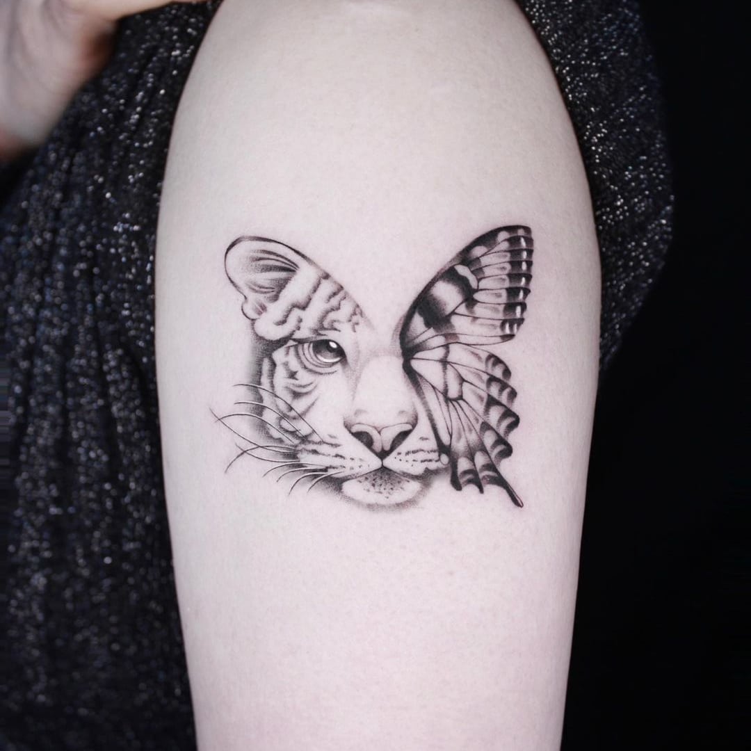Tattoo of a white tiger and butterfly on skin