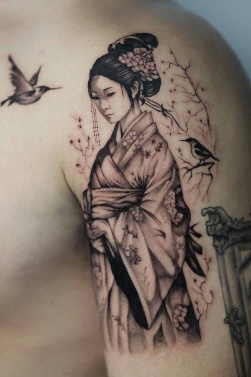 Tattoo art of a Japanese woman in kimono with birds