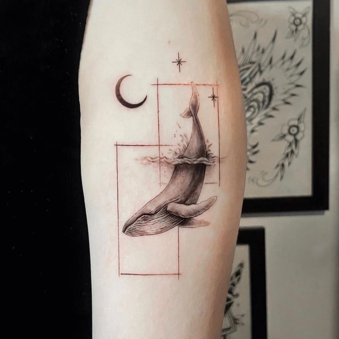 Tattoo of a whale surrounded by geometric shapes and moon