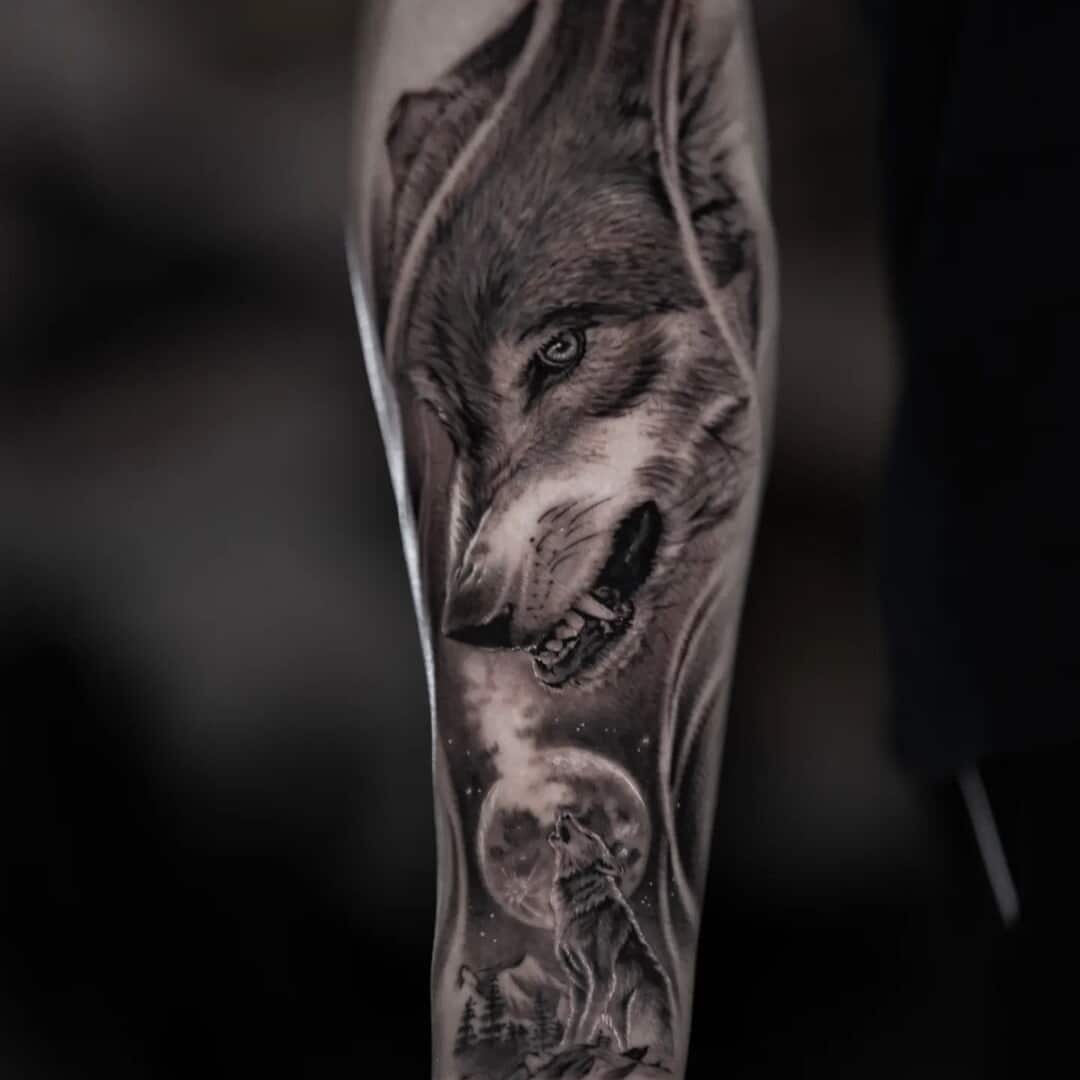 Black and grey wolf tattoo on forearm
